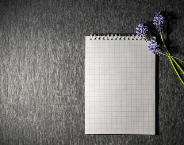 Notepad with flowers on black background