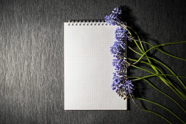 Notepad with flowers on black background