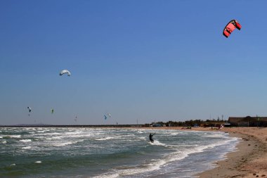 Deniz dalgalarında kitesurf. Kitesurf yapan insanların panoramik görünümü