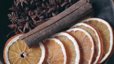 Yıldız anason tarçın çubukları ve vintage kase içinde dönen portakal kurutulmuş dilimleri.