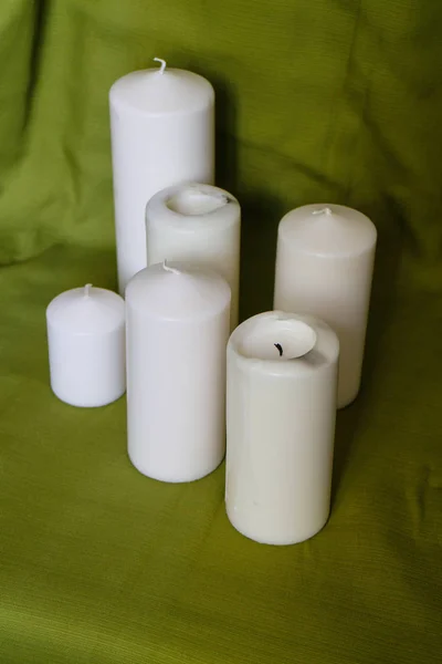 The candles, glassware and green drapery. — Stock Photo, Image