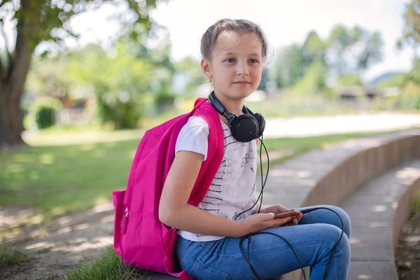 Cute Happy Girl Pink Backpack Sits Schoolyard Street Headphones Her — Stock Photo, Image