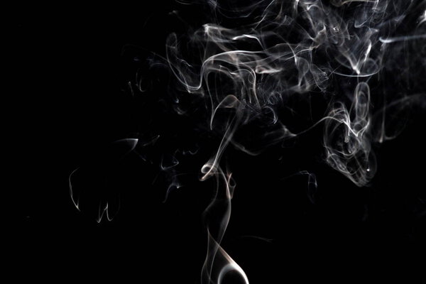 White smoke swirling against a dark background