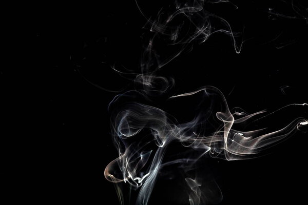 Swirls of smoke against dark background