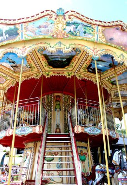 Mavi yaz gökyüzü arka plan üzerinde park açık güzel parlak atlar ile Carousel karnaval vintage.