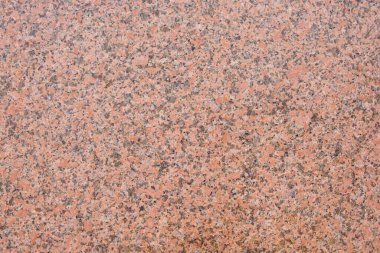 Siyah lekeli koyu pembe granit desenli. Doğal bir taş.