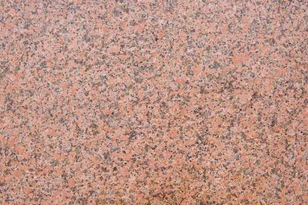 Siyah lekeli koyu pembe granit desenli. Doğal bir taş.