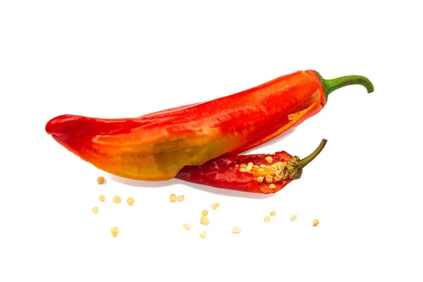 Two red chili peppers with seeds from within on a white background. — Stock Photo, Image