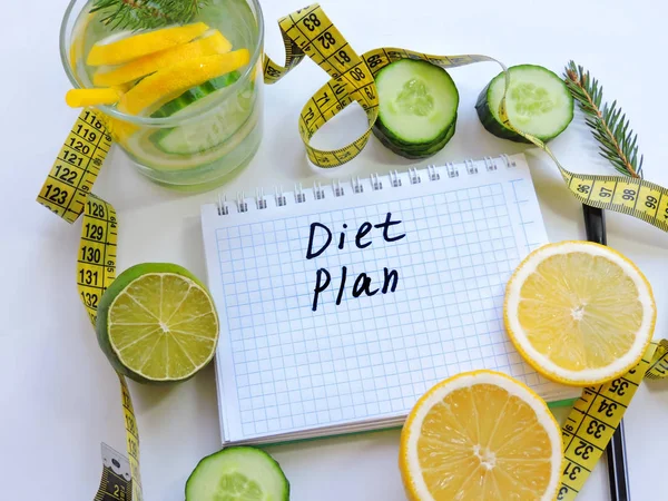 Healthy eating, dieting, slimming and weigh loss concept.Diet plan book.Diet plan notebook and fruits with copy space for healthy food concept.Diet plan concept background. blank recipe book
