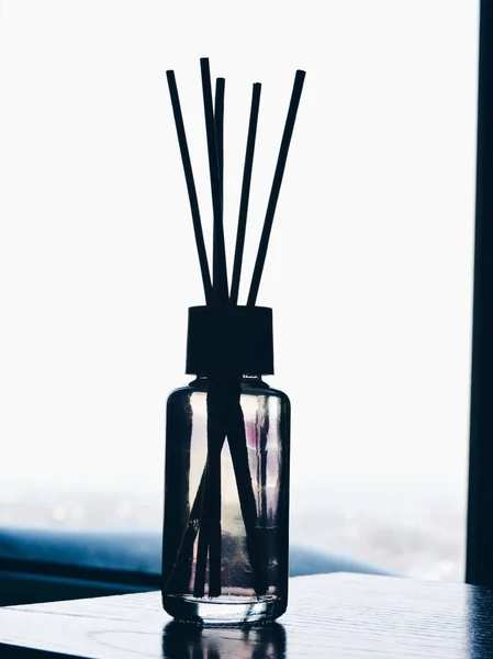 Air freshener sticks at home.Air refresher bottle and wooden sticks on table with copy space.meditating. — Stock Photo, Image
