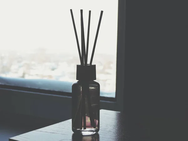 Air freshener sticks at home.Air refresher bottle and wooden sticks on table with copy space.meditating.