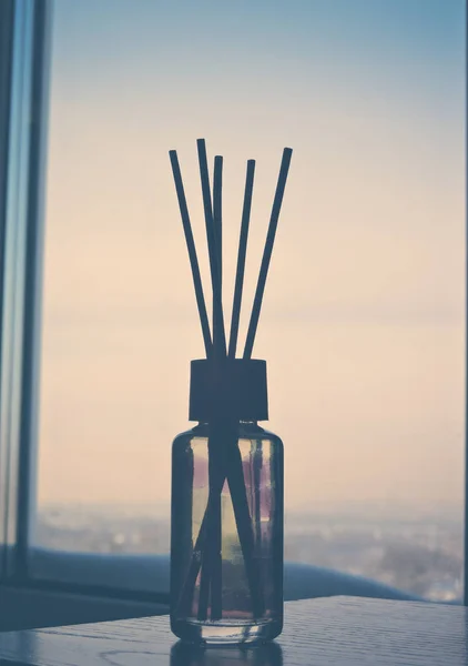 Air freshener sticks at home.Air refresher bottle and wooden sticks on table with copy space.meditating.