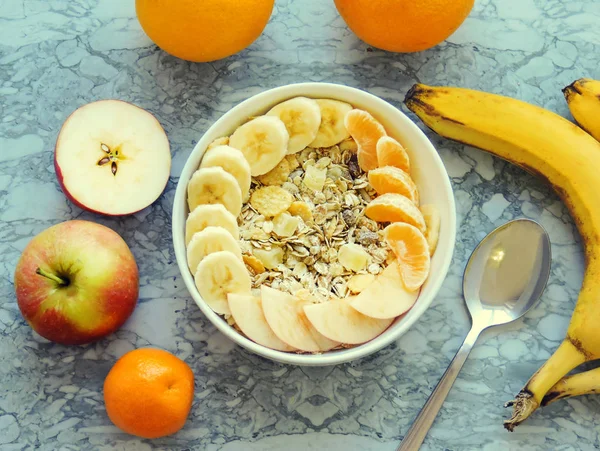 Healthy breakfast. Close-up, top view, isolated background. Concept of healthy and tasty food. Fitness breakfast. muesli bowl with sliced banana. Muesli breakfast with oatmeal cereals raisins.