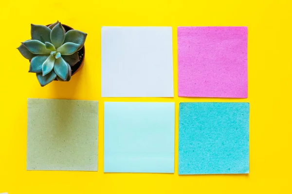 Colored notes paper. Post reminder papers.Sticky note paper reminder. Empty place for text. Set of different colored sticky note on a yellow background.