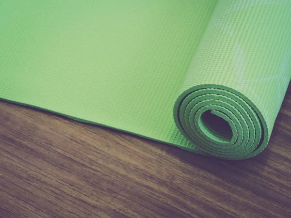 top view.Healthy life, keep fit concepts.Equipment for yoga. Top view green  yoga mat sport isolated.Rolled up yoga mat isolated on white. Copyspace.