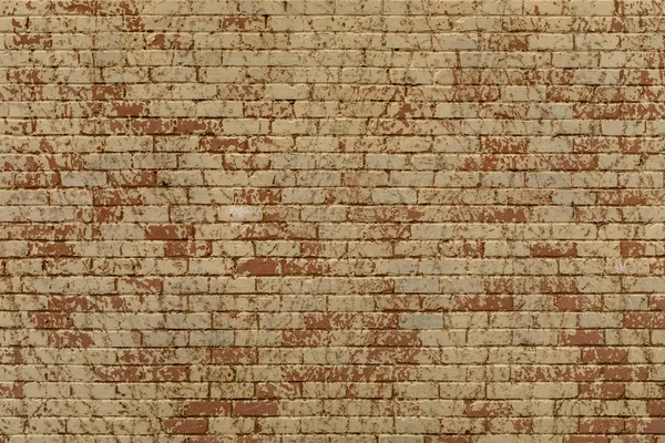 Велика кремова, червона та помаранчева пофарбована цегляна стіна, повторюваний візерунок ідеально підходить для фону або текстури — стокове фото