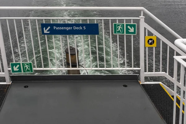 Signs and directions on the back of the ferry pointing to lower decks heading up the Inside Passage, Canada — Stock Photo, Image