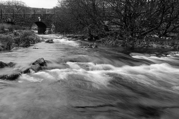 Black and white image of the River Lyd running under the B3357 on Dartmoor — Stock Photo, Image