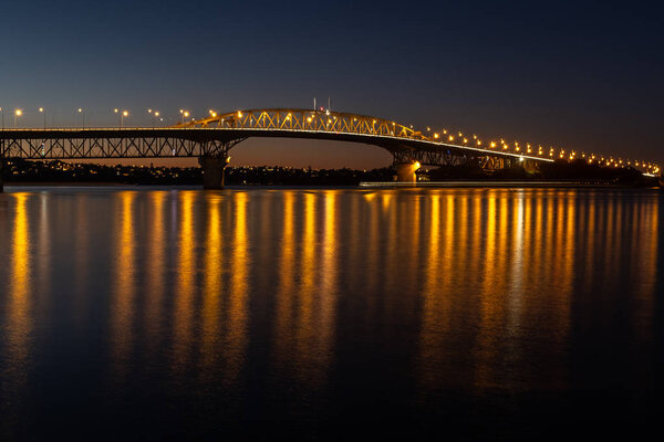 The Auckland harbour bridge lit up at night