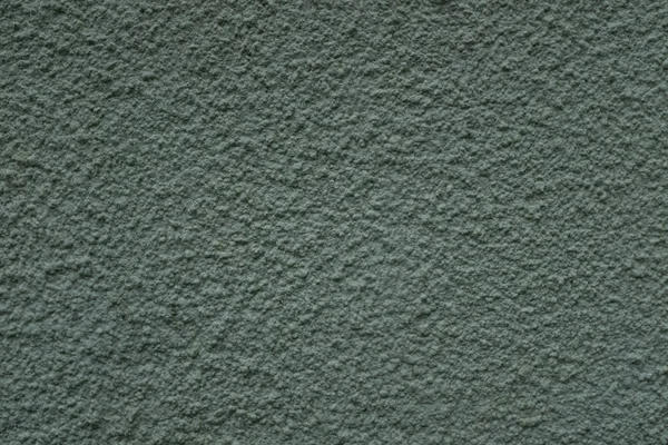 Uma foto de close-up de uma parede exterior pintada de verde texturizado, superfície com estuque daub, ótimo para fundo — Fotografia de Stock