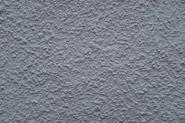 Крупним планом фото зовнішньої фактурної стіни, пофарбованої в сірий колір, поверхня з ліпниною, відмінно підходить для фону — стокове фото