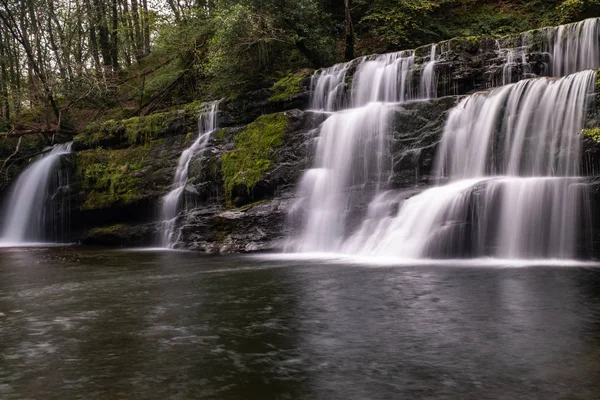 Low level view with a long exposure shot of waterfall, in the Brecon Beacons, Wales scenic waterfall with flowing water,
