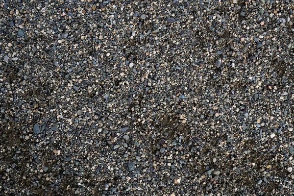 A textura de uma pedra rasa do rio. Imagem de fundo de seixo — Fotografia de Stock