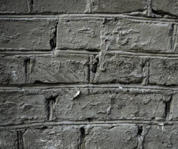 Текстура старої фарби покрита цегляною стіною. Зображення тла — стокове фото