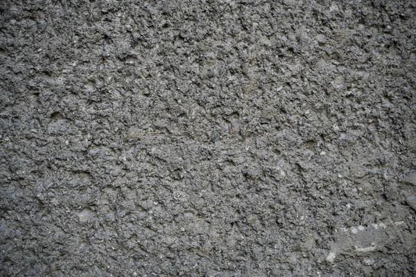 Konsistens av en gammal sprucken betongvägg. Bakgrundsbild av en w — Stockfoto