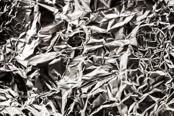 Buruşmuş folyo dokusu. Buruşmuş alüminyum folyonun arkaplan resmi.