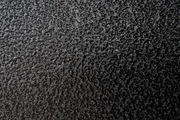 Detailed metal coating texture. Corrosion-resistant coating. Abstract background. A closeup. Dark colors. Background image. Space for text. Desktop wallpaper. Top view.