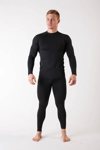 The guy in thermal underwear on a white background. Sportswear. — Stock Photo, Image