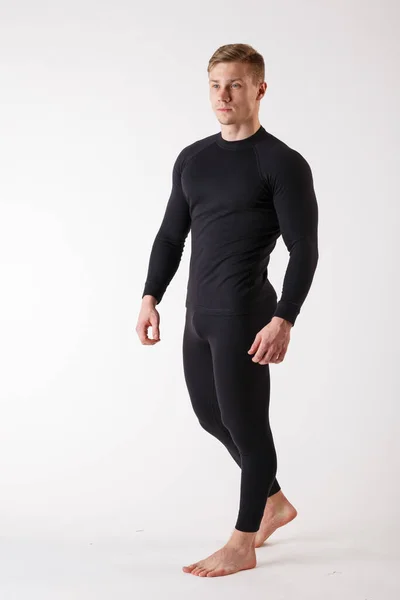 The guy in thermal underwear on a white background. Sportswear. — Stock Photo, Image