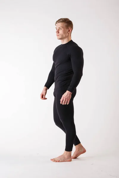 The guy in thermal underwear on a white background. Sportswear. — Stock Photo, Image