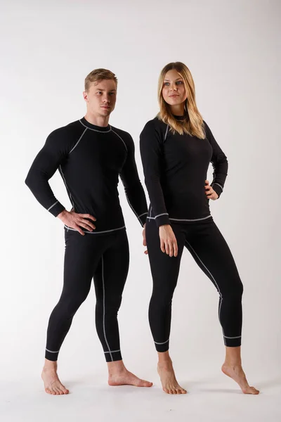 Guy e menina em roupa interior térmica em um fundo branco — Fotografia de Stock