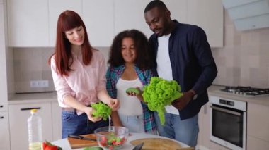 Afrikalı Amerikalı kız Vanessa annesi ve babası mutfakta salata hazırlıyorlar..