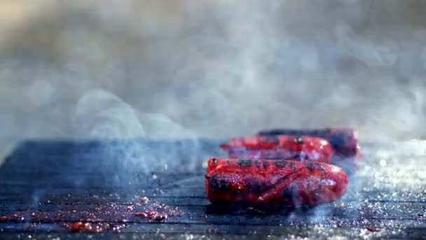 Saucisse en fumée sur le feu de barbecue