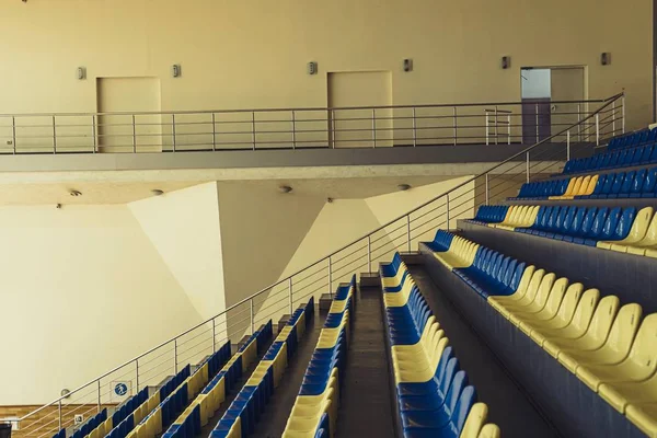 Stadium Seats. Sport arena blue and yellow plastic seats. Indoor. — Stock Photo, Image
