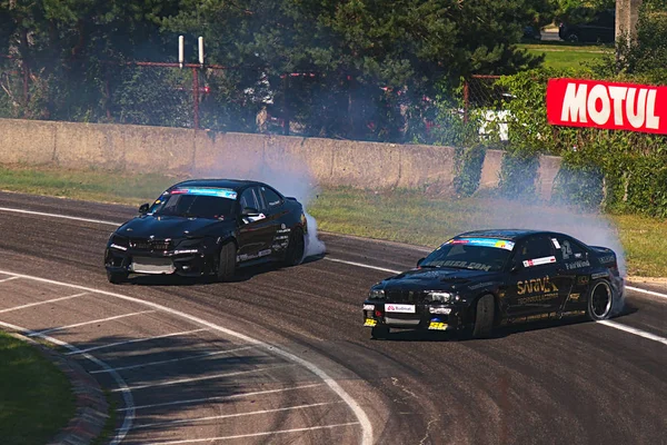 Riga, Latvia - August 02, 2019 - Two BMW drifting through first corners of the track — Stock Photo, Image