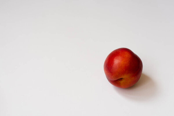 Fresh organic nectarine on white background