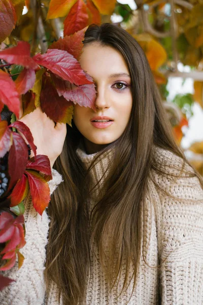 Autumn mood! Young woman with autumn leaves in her hand