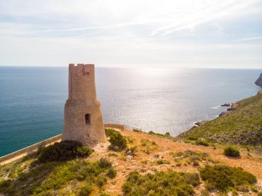 Torre del Gerro tower. Ancient 16th century watchtower on the top of a cliff in Denia, Spain clipart