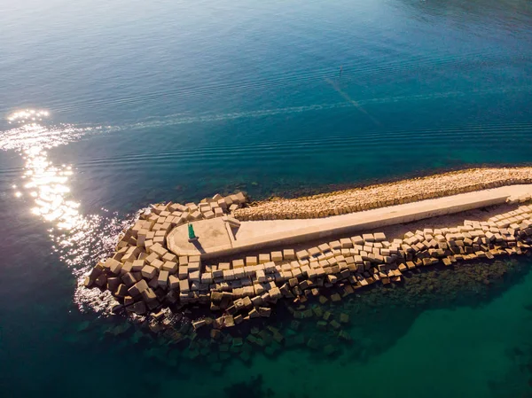 Aerial drone view of a breakwater and a lighthouse in Denia port — Stock Photo, Image