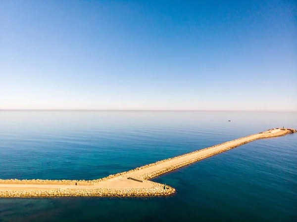 Aerial drone view of a breakwater and a lighthouse in Denia port — Stock Photo, Image