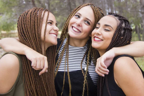 Three young and beautiful girls, with braided hair, having fun — Stock Photo, Image