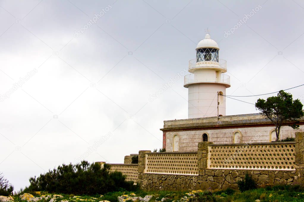 LIghthouse in the cape of San Antonio, in Javea, Spain, on a cloudy day