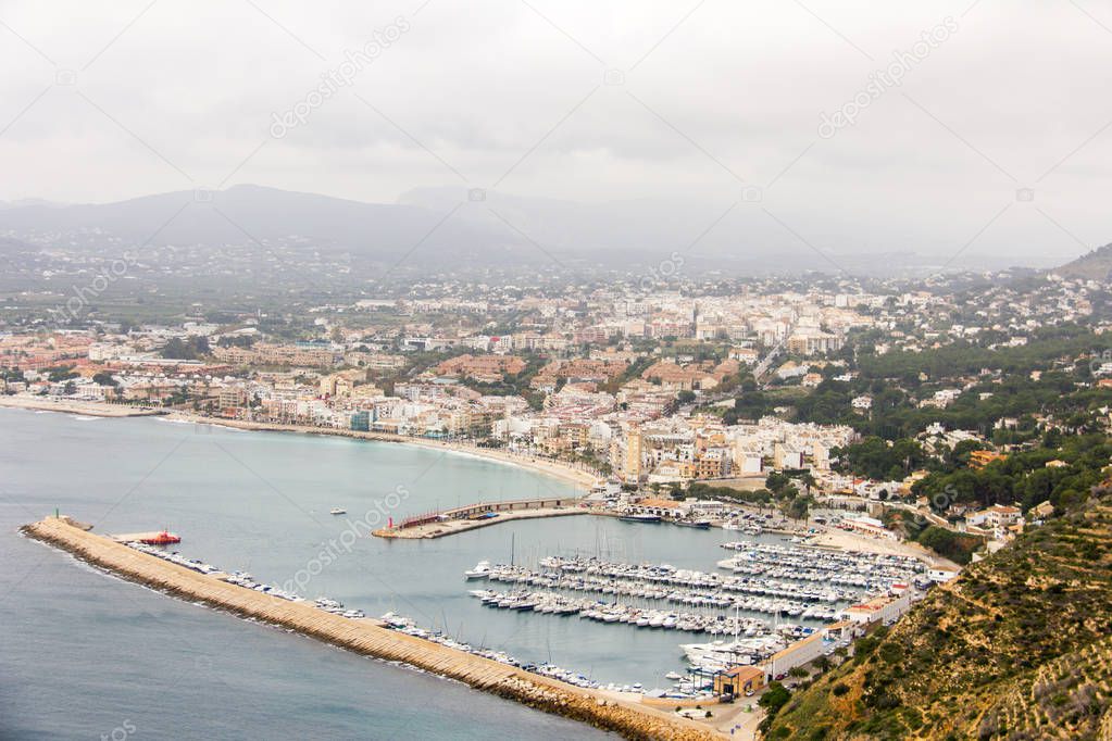 Aerial view of Javea harbor in Spain, from the cape of San Antonio on a cloudy day