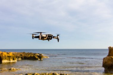 A drone flying over the beach in Denia, Spain clipart