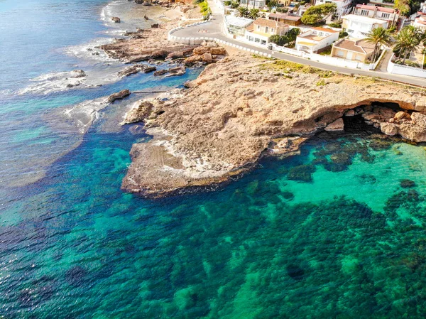 Vista aérea de la playa rocosa de Las Rotas en Denia, España al atardecer — Foto de Stock