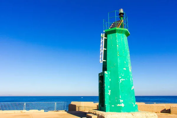 A green lighthouse in Denia, Spain. The blue sky is in the background — Stock Photo, Image